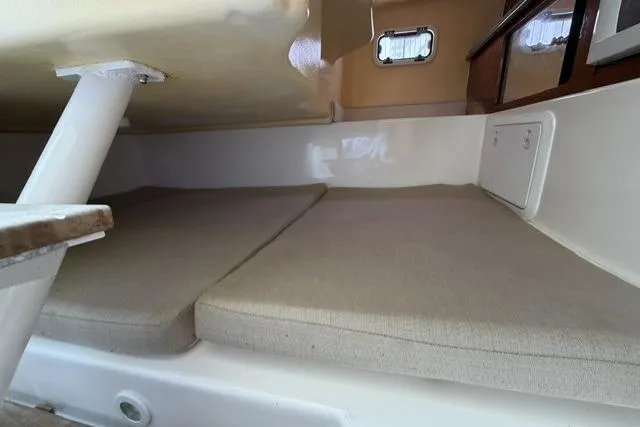 Slide: The Image of Interior cabin of 2003 Edgewater 265 Express boat with cushioned seating. - 13