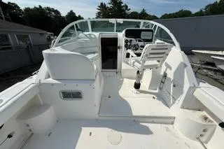 Slide: The Image of 2003 Edgewater 265 Express boat interior with white seating and control panel. - 30