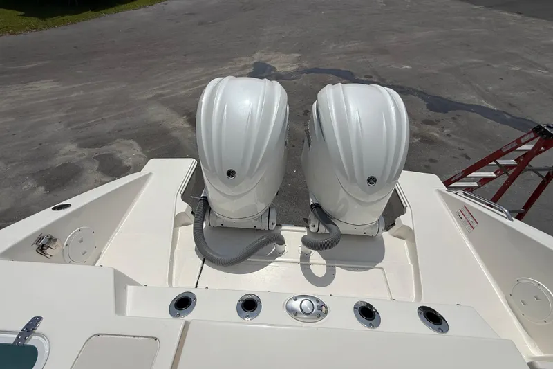 Slide: The Image of 2024 Pursuit DC 306 Dual Console with twin outboard engines, rear view. - 42