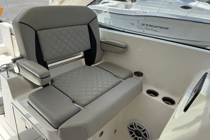 Slide: The Image of 2024 Pursuit DC 306 Dual Console boat seat with quilted design and cup holders. - 22