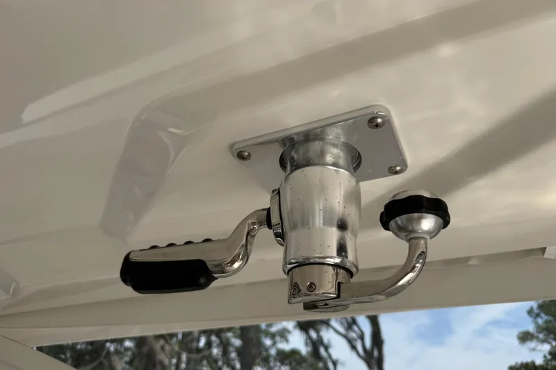 Slide: The Image of Close-up of a 2024 Pursuit DC 306 Dual Console boat handle mechanism. - 24