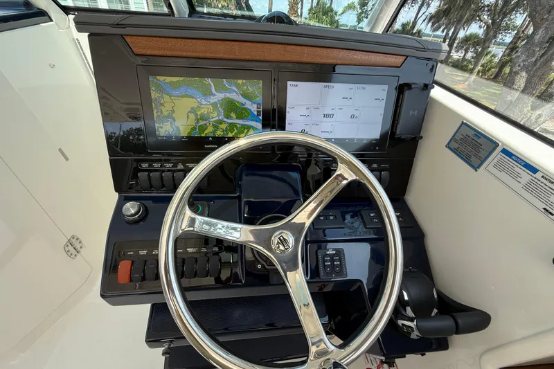 Slide: The Image of 2024 Pursuit DC 306 Dual Console dashboard with navigation screens and steering wheel. - 25