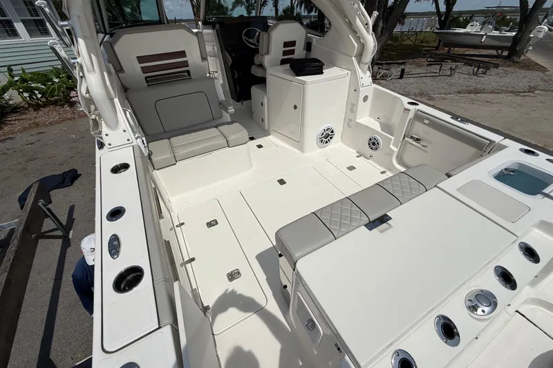 Slide: The Image of 2024 Pursuit DC 306 Dual Console boat interior with seating and storage features. - 11