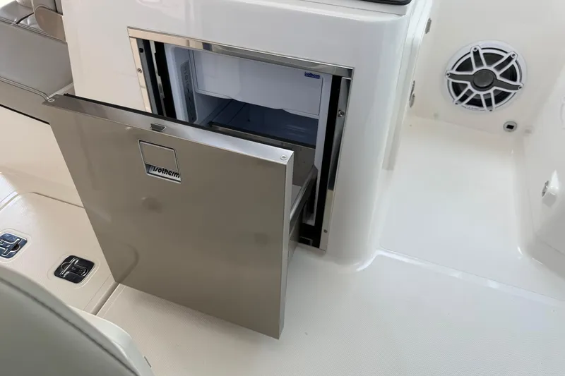Slide: The Image of Open stainless steel drawer on 2024 Pursuit DC 306 Dual Console boat. - 29