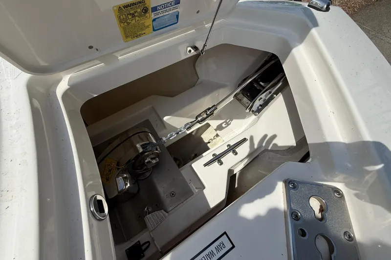 Slide: The Image of 2024 Pursuit DC 306 Dual Console anchor compartment with chain and winch system. - 39
