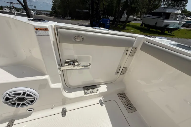 Slide: The Image of 2024 Pursuit DC 306 Dual Console boat interior with door and speaker detail. - 16