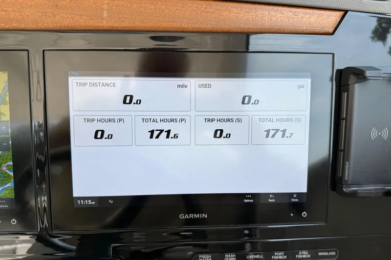 Slide: The Image of Garmin display on 2024 Pursuit DC 306 Dual Console showing trip and total hours. - 27