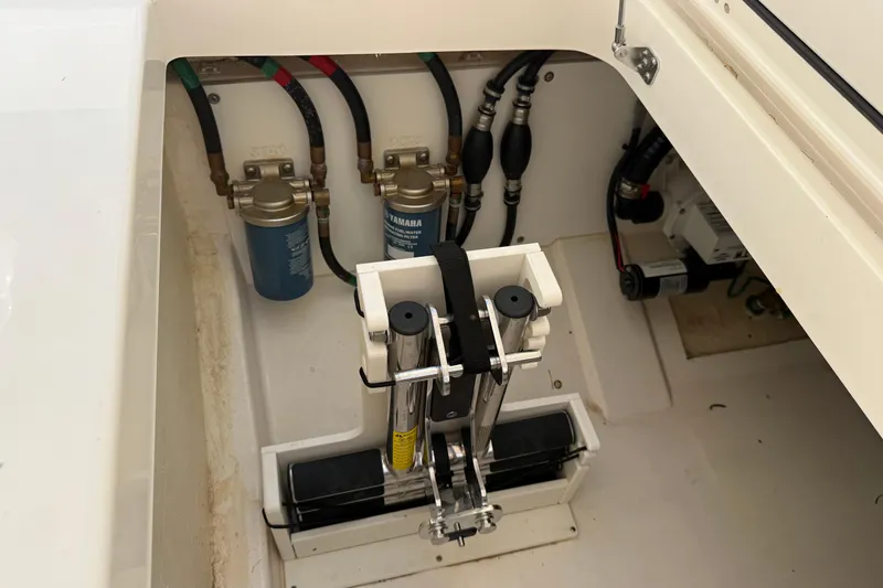 Slide: The Image of Engine compartment of 2024 Pursuit DC 306 Dual Console boat, showcasing fuel filters and hydraulic components. - 17