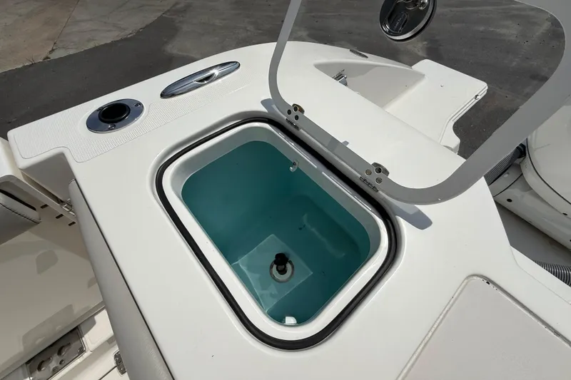 Slide: The Image of Open storage compartment on 2024 Pursuit DC 306 Dual Console boat. - 15