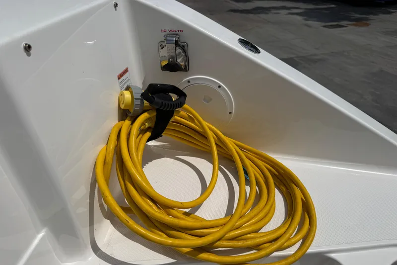 Slide: The Image of Yellow power cable on 2024 Pursuit DC 306 Dual Console boat deck. - 44