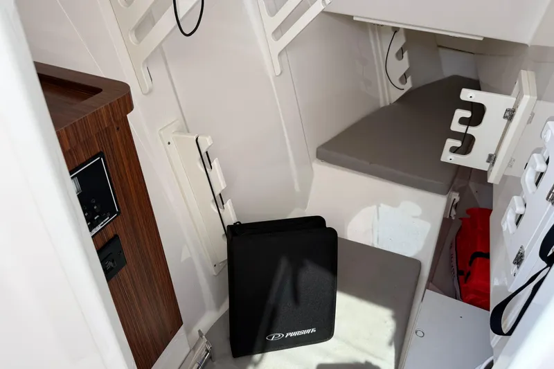 Slide: The Image of 2024 Pursuit DC 306 Dual Console cabin interior with seating and storage. - 33