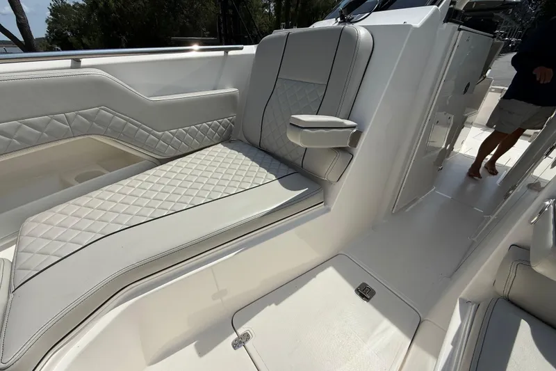 Slide: The Image of 2024 Pursuit DC 306 Dual Console boat interior with luxurious seating and modern design. - 36
