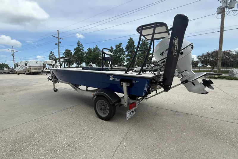 Slide: The Image of 2020 Skimmer Skiff 14 boat with motor on trailer, parked outdoors. - 6