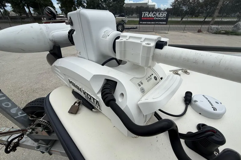 Slide: The Image of Minn Kota trolling motor on 2020 Skimmer Skiff 14 boat, parked near Tracker Boats sign. - 11