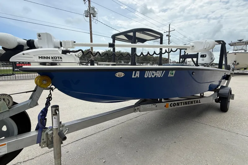 Slide: The Image of 2020 Skimmer Skiff 14 boat on trailer with Minn Kota Terrova motor, parked outdoors. - 4