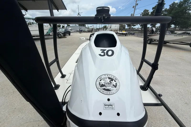 Slide: The Image of 2020 Skimmer Skiff 14 boat with ultra-low emission technology, docked outdoors. - 9