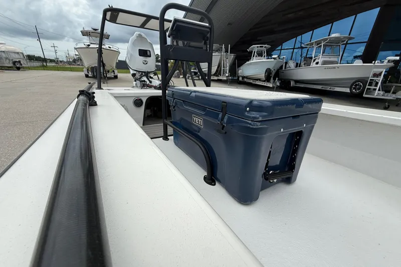 Slide: The Image of 2020 Skimmer Skiff 14 boat with YETI cooler, docked near other boats. - 12