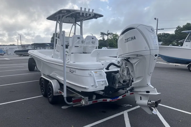 Slide: The Image of 2026 BlackJack 256 Coastal boat with Yamaha engine on trailer in parking lot. - 6