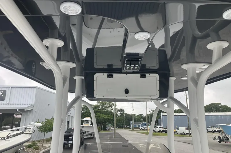 Slide: The Image of 2026 BlackJack 256 Coastal boat's T-top with integrated lighting and storage compartments. - 8