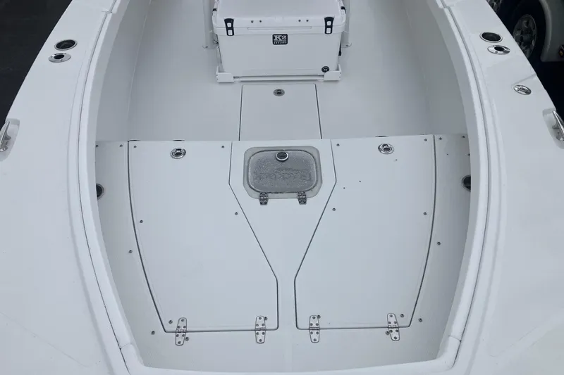Slide: The Image of 2026 BlackJack 256 Coastal boat deck with storage compartments and seating area. - 14