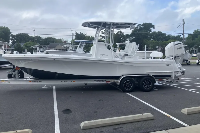 Slide: The Image of 2026 BlackJack 256 Coastal boat on trailer in parking lot. - 3
