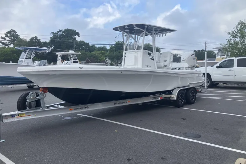 Slide: The Image of 2026 BlackJack 256 Coastal boat on trailer in parking lot, ready for transport. - 2