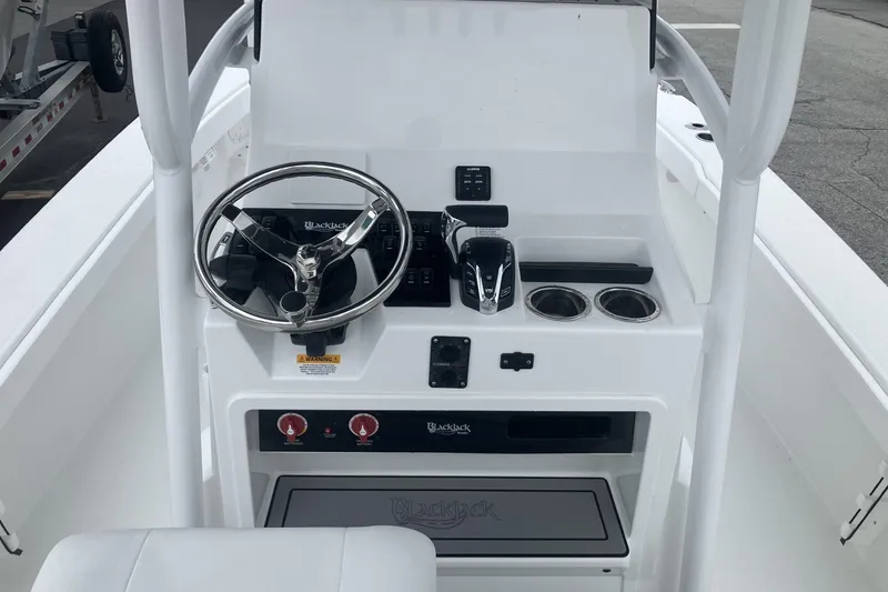 Slide: The Image of 2026 BlackJack 256 Coastal boat console with steering wheel and controls. - 9