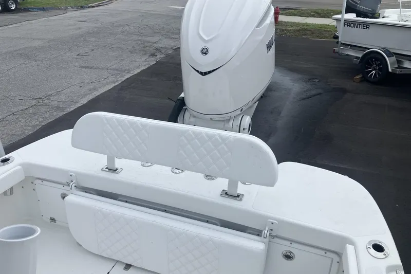 Slide: The Image of 2026 BlackJack 256 Coastal boat with white seating and powerful outboard motor. - 11