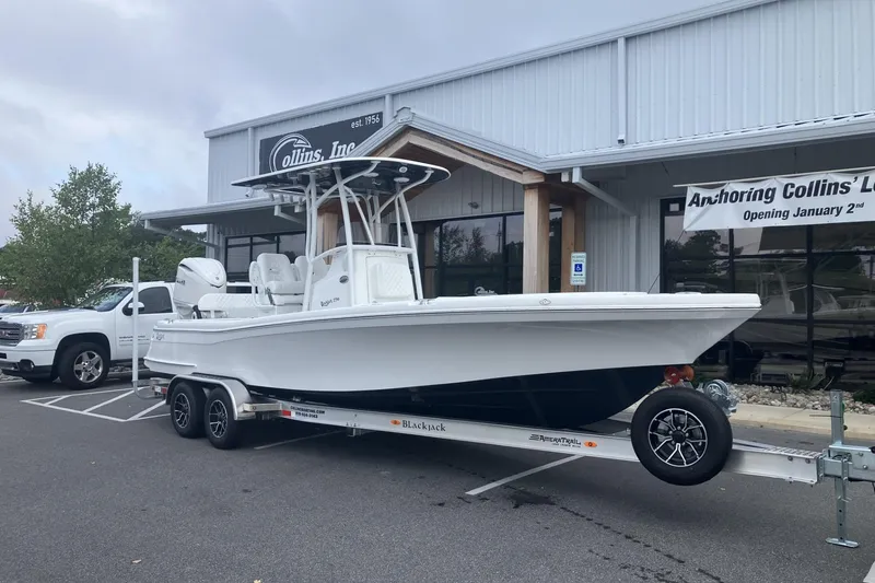 The Image of 2026 BlackJack 256 Coastal boat on trailer outside dealership. - 0