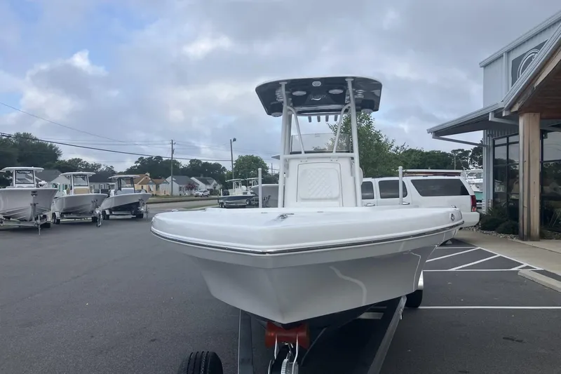 Slide: The Image of 2026 BlackJack 256 Coastal boat on trailer at dealership, overcast sky. - 5