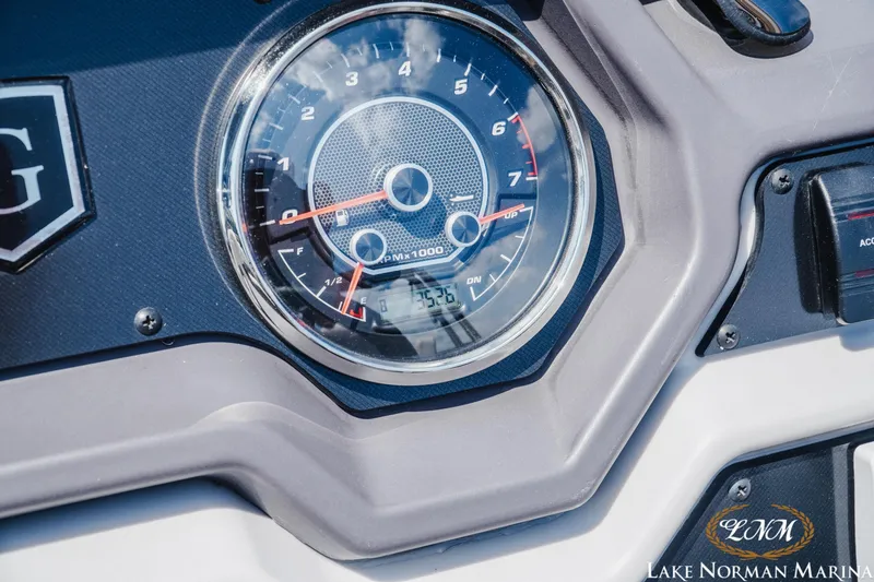 Slide: The Image of Close-up of 2023 Godfrey Sweet Water 2286 SFL boat dashboard with tachometer gauge. - 19