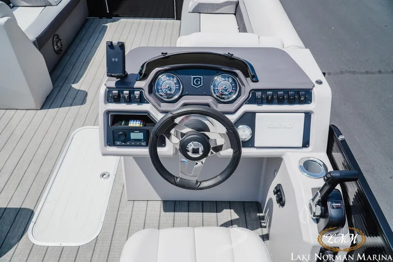 Slide: The Image of 2023 Godfrey Sweet Water 2286 SFL boat dashboard with steering wheel and controls. - 10