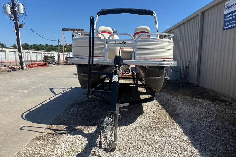 Slide: The Image of 2008 Sun Tracker Fishin' Barge 21 Signature Series on trailer, parked outdoors. - 2