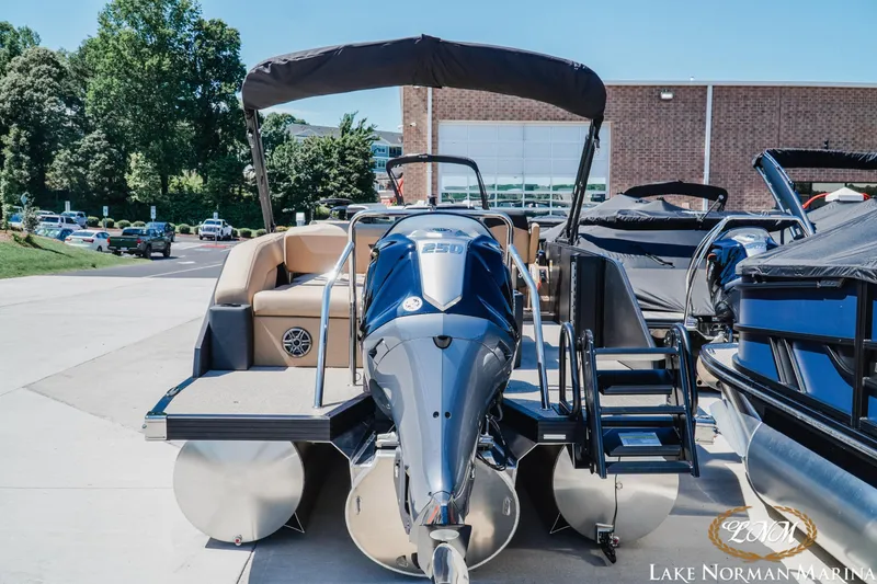 Slide: The Image of Evotti 523CS 2026 pontoon boat at Lake Norman Marina, featuring a powerful outboard motor. - 5