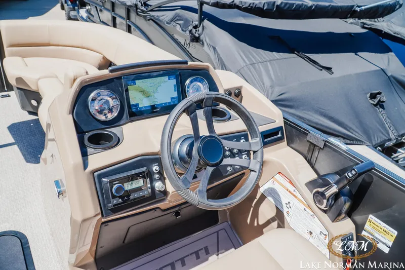 Slide: The Image of Cockpit of 2026 Evotti 523CS boat with modern navigation system and controls at Lake Norman Marina. - 12