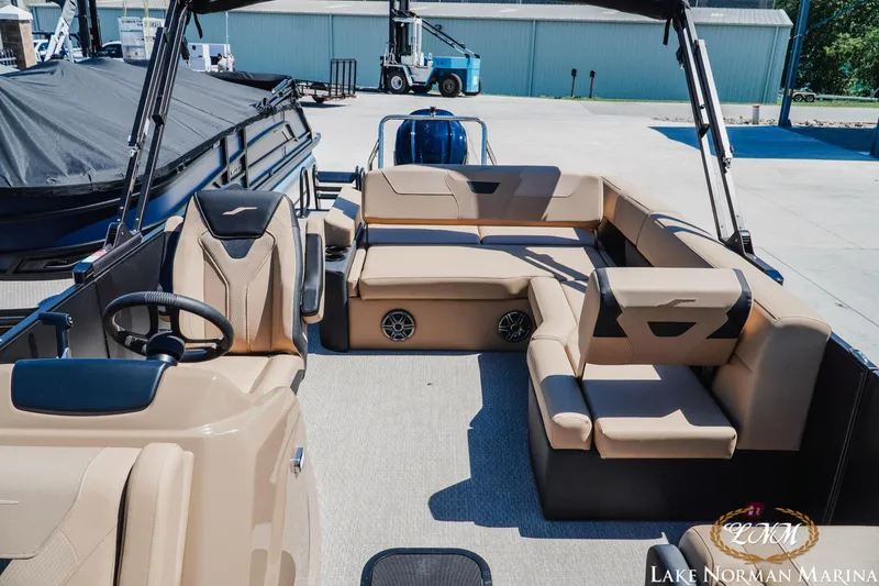 Slide: The Image of 2026 Evotti 523CS boat interior with beige seating at Lake Norman Marina. - 18