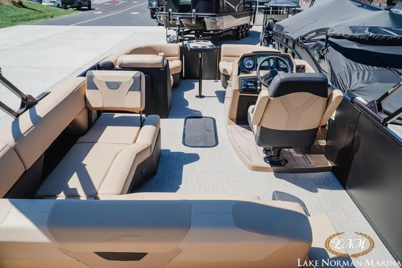Slide: The Image of 2026 Evotti 523CS boat interior with beige seating and modern dashboard at Lake Norman Marina. - 6