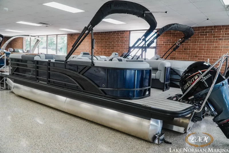 Slide: The Image of 2027 Bennington 23SSR pontoon boat displayed indoors at Lake Norman Marina. - 3