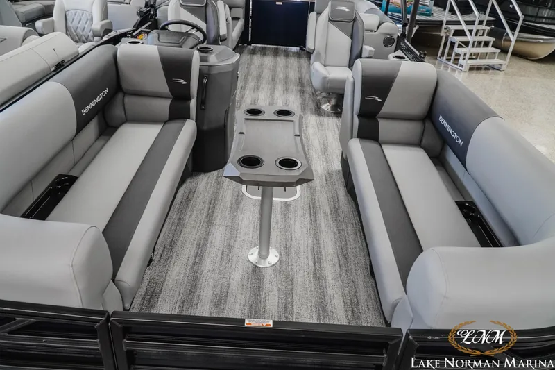 Slide: The Image of 2027 Bennington 23SSR pontoon boat interior with gray seating and central table. - 14