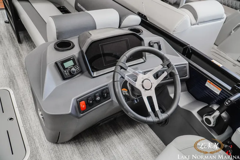 Slide: The Image of 2027 Bennington 23SSR boat dashboard with steering wheel and control panel. - 11