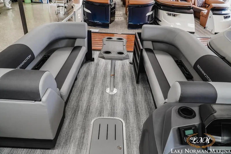 Slide: The Image of 2027 Bennington 23SSR pontoon boat interior with gray seating and central table. - 12