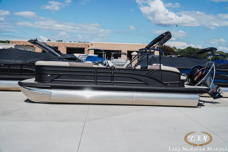 The Image of 2027 Bennington 23SSB pontoon boat at Lake Norman Marina under a clear blue sky. - 1