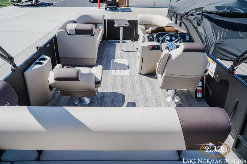 Slide: The Image of Interior view of a 2027 Bennington 23ssb pontoon boat with luxurious seating and modern dashboard. - 6