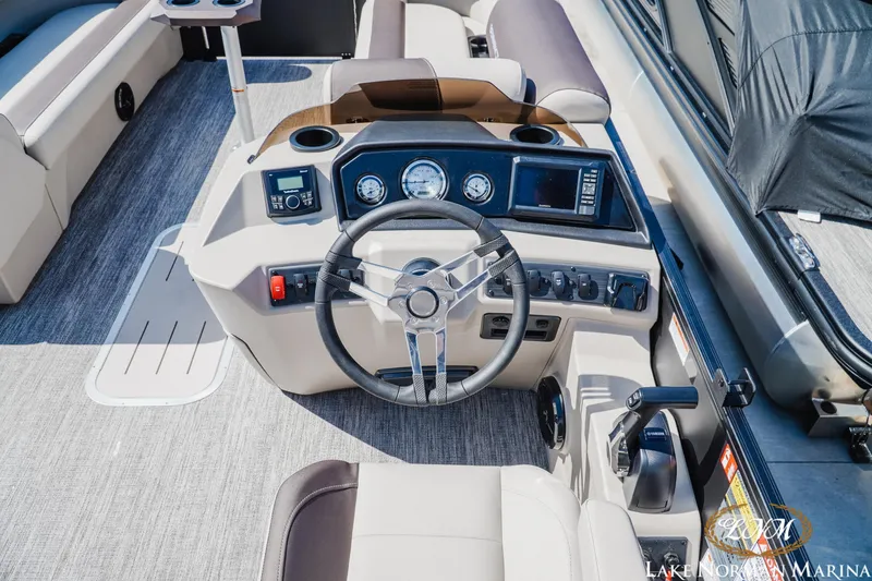 Slide: The Image of 2027 Bennington 23ssb boat dashboard with steering wheel and control panel. - 11