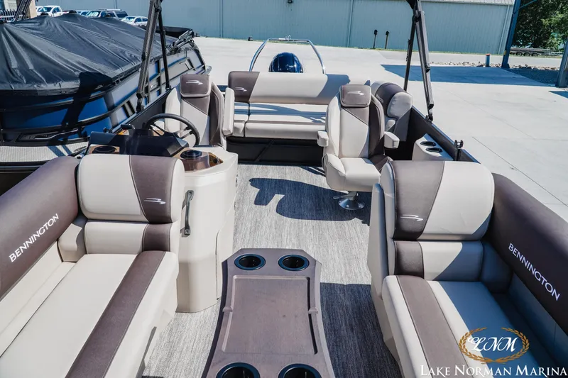 Slide: The Image of 2027 Bennington 23ssb pontoon boat interior with plush seating at Lake Norman Marina. - 14