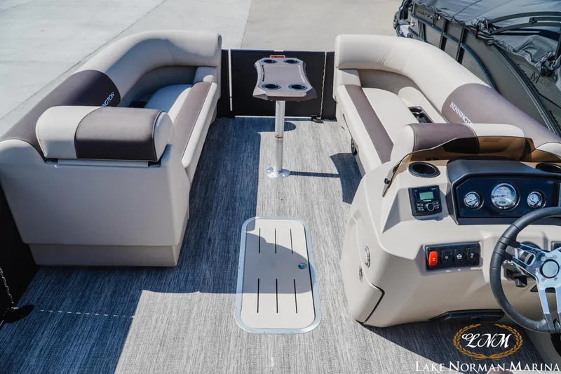 Slide: The Image of 2027 Bennington 23ssb pontoon boat interior with plush seating and modern dashboard. - 9