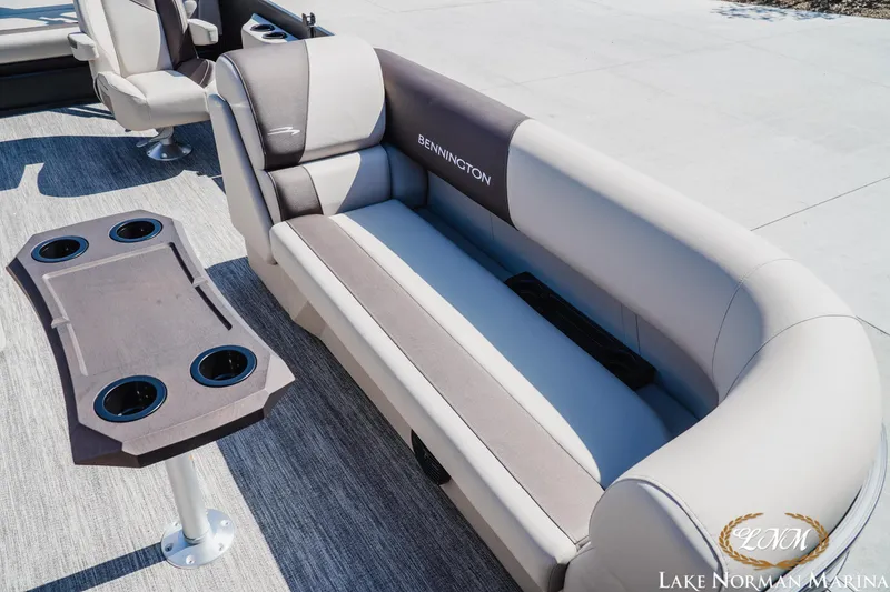 Slide: The Image of 2027 Bennington 23SSB pontoon boat interior with plush seating and cup holders. - 17