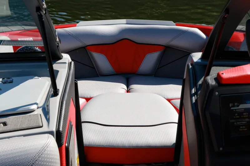 Slide: The Image of Interior view of 2024 Centurion Fi23 boat, featuring sleek red and gray seating. - 13