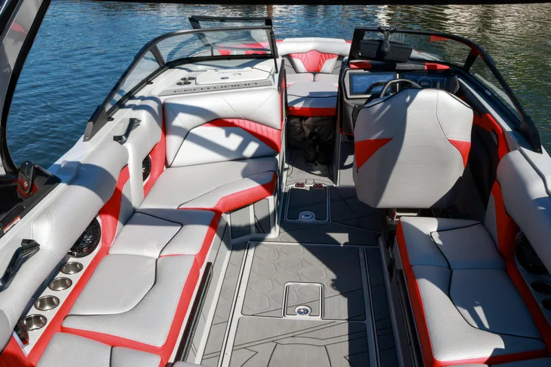 Slide: The Image of 2024 Centurion Fi23 boat interior with red and white seating, sleek design, and modern dashboard. - 9
