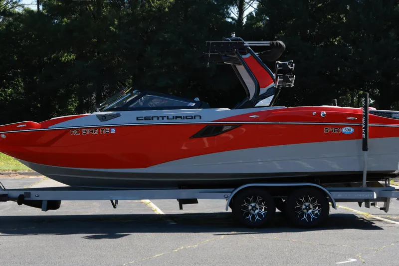 Slide: The Image of 2024 Centurion Fi23 boat on trailer, vibrant red and gray design. - 19